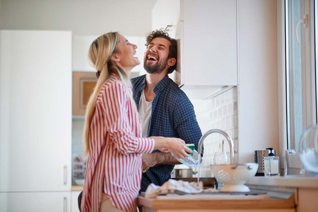 A happy couple in thier cozy warm kitchen highlighting the feeling our customers have after a visit bu our plumbers in Reading