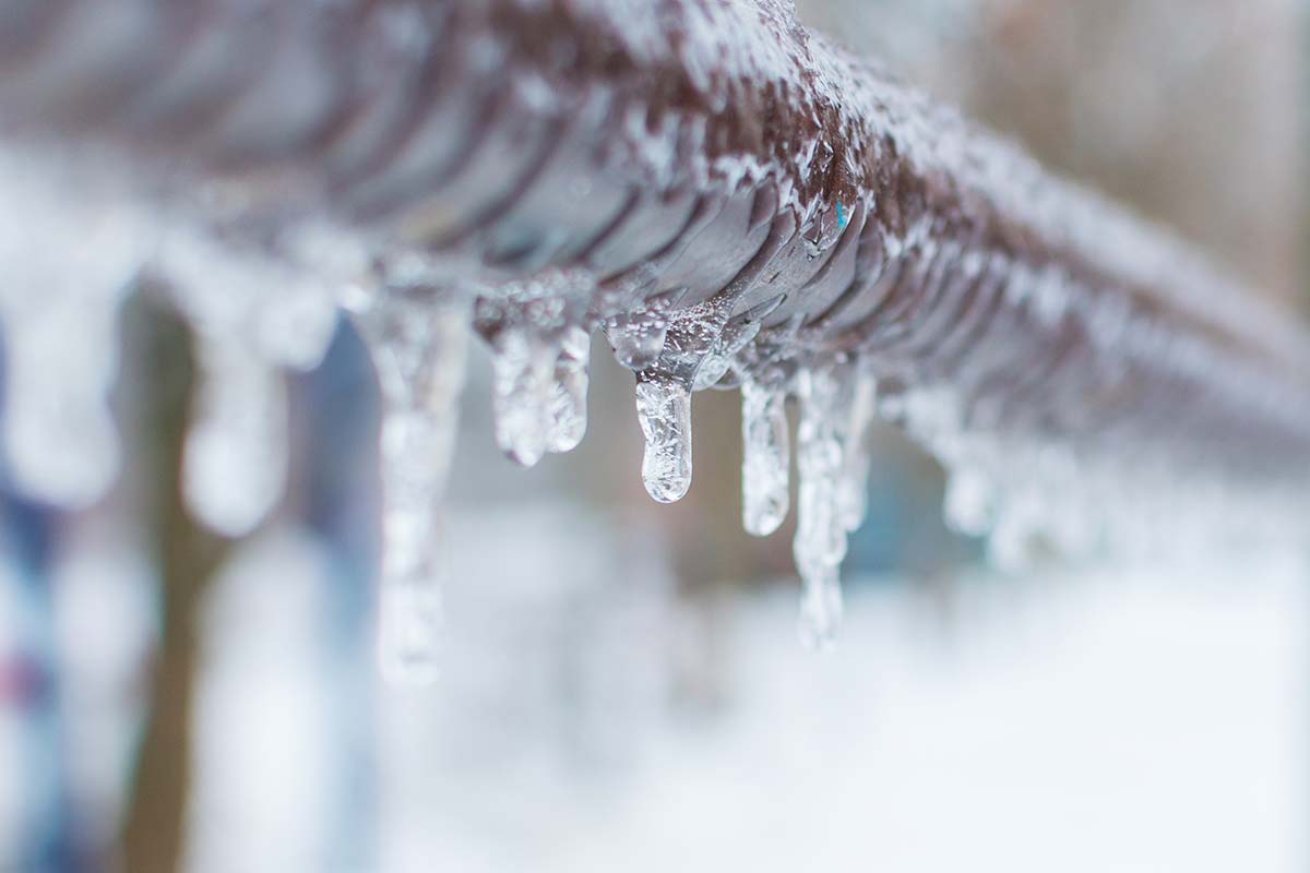 A frozen pipe dripping frozen water