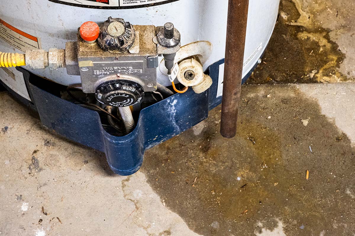 Hot water heater base with a leak indicating it's not working