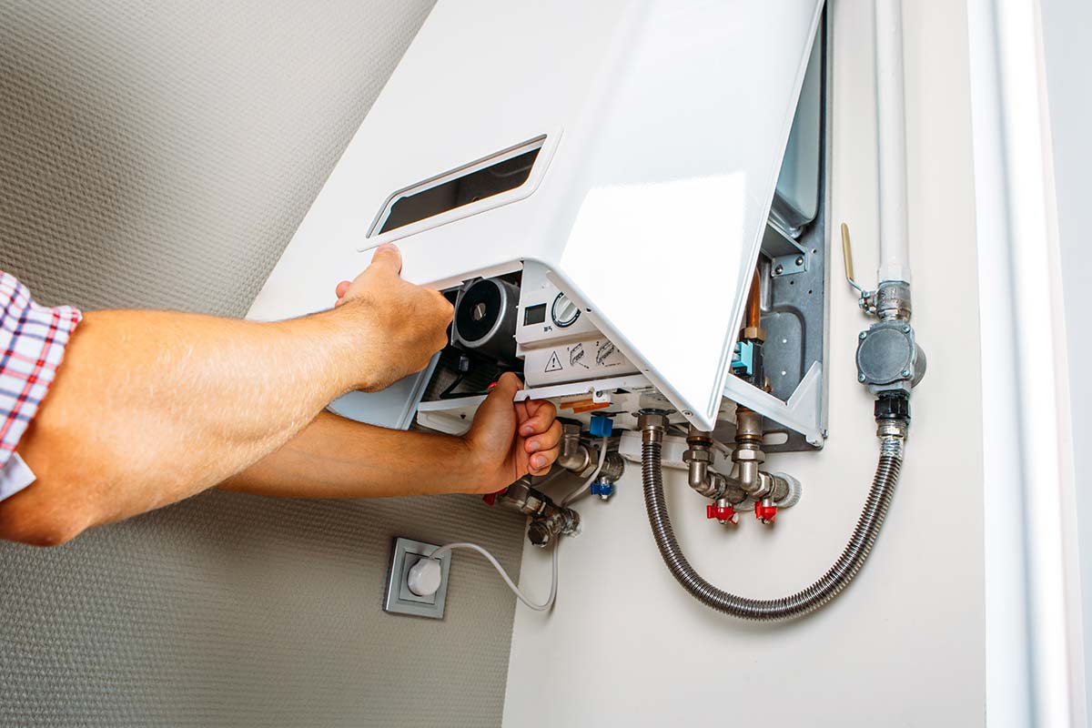 Technician servicing a malfunctioning tankless hot water heater