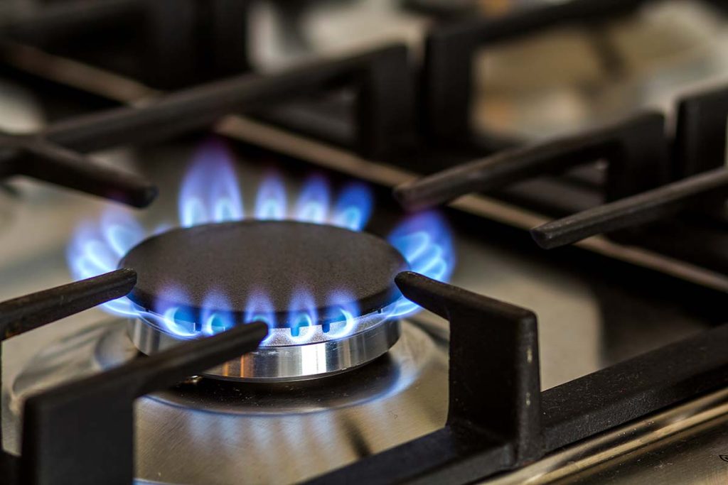 A close-up view of a gas stove burner, symbolizing Lund Plumbing and Heating's commitment to safe and proficient plumbing services for the Wakefield, Massachusetts community.