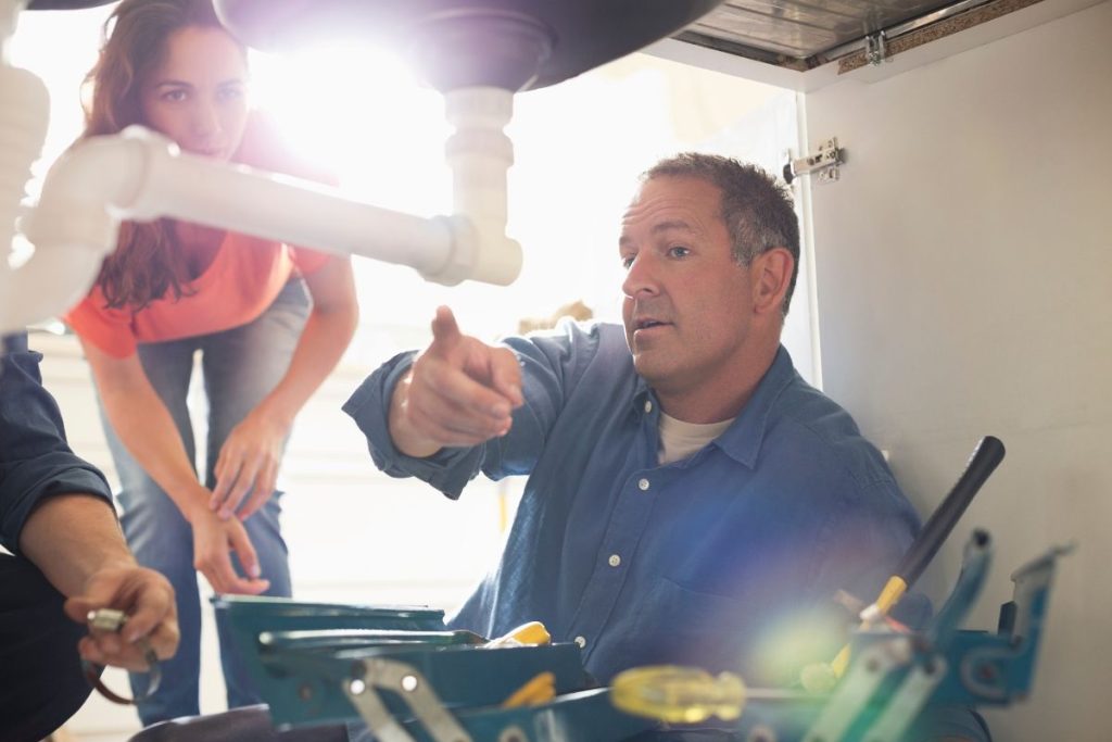 A kitchen plumber fixing a clogged drain